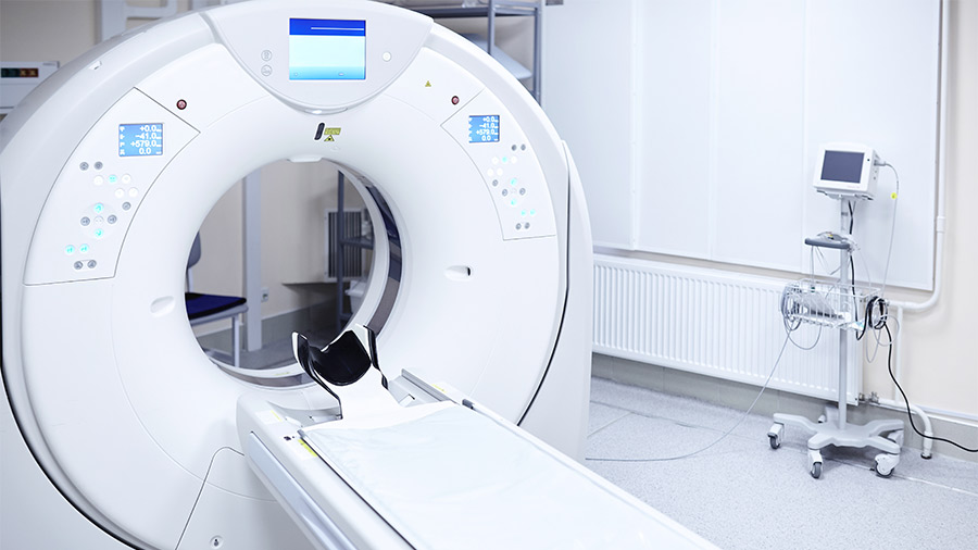 An MRI machine in a white hospital room
